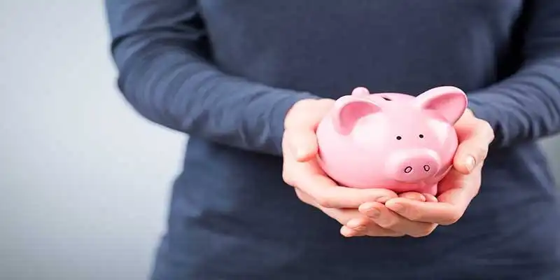 © ptnphotof - Fotolia | Care for Savings - Woman with a Piggy Bank