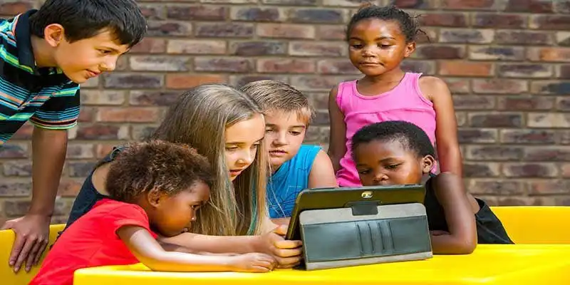 © karelnoppe - stock.adobe.com | Diverse group of kids looking at tablet.