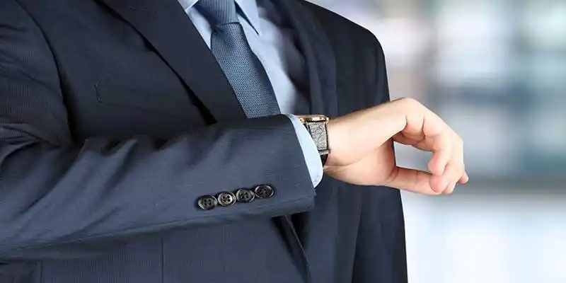 © Saklakova - Fotolia | businessman checking time on his watch .